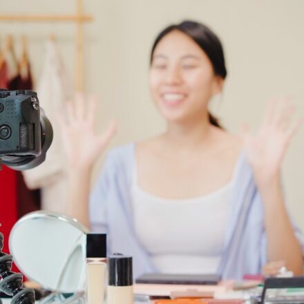 Beauty blogger present beauty cosmetics sitting in front camera